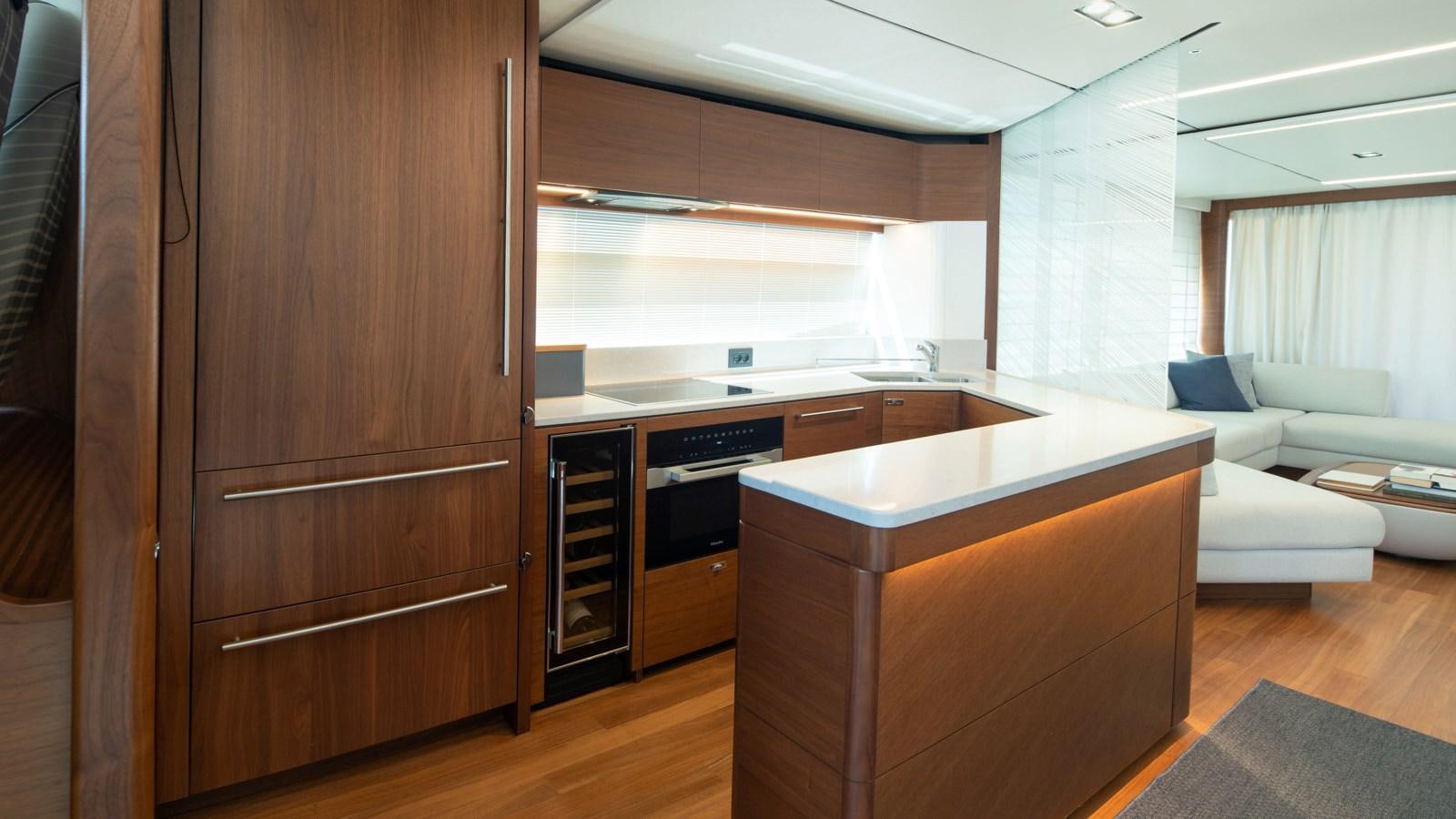 a kitchen with a large wooden cabinet aboard SERENATA Yacht for Sale