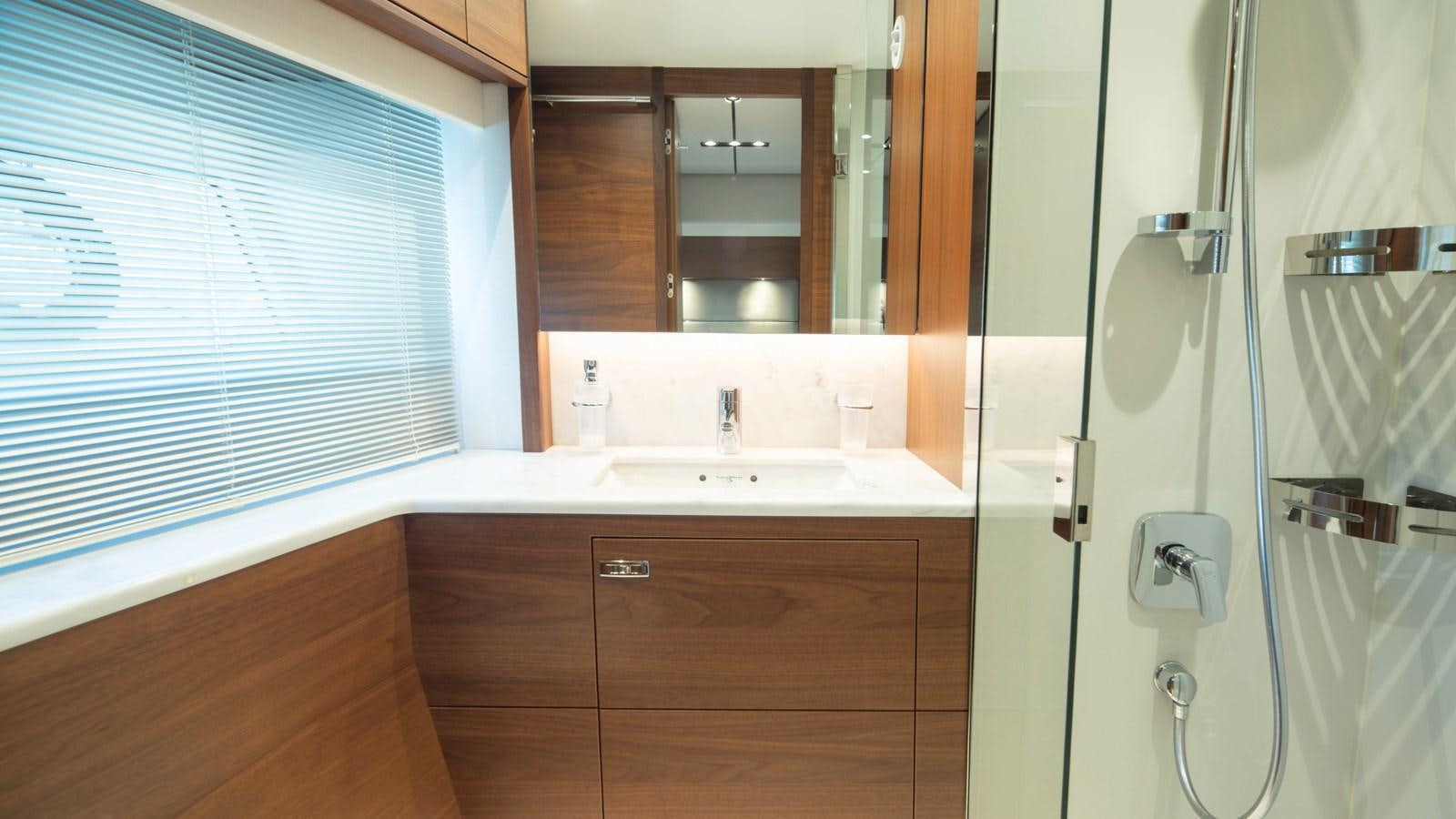 a bathroom with a shower unit and sink aboard SERENATA Yacht for Sale