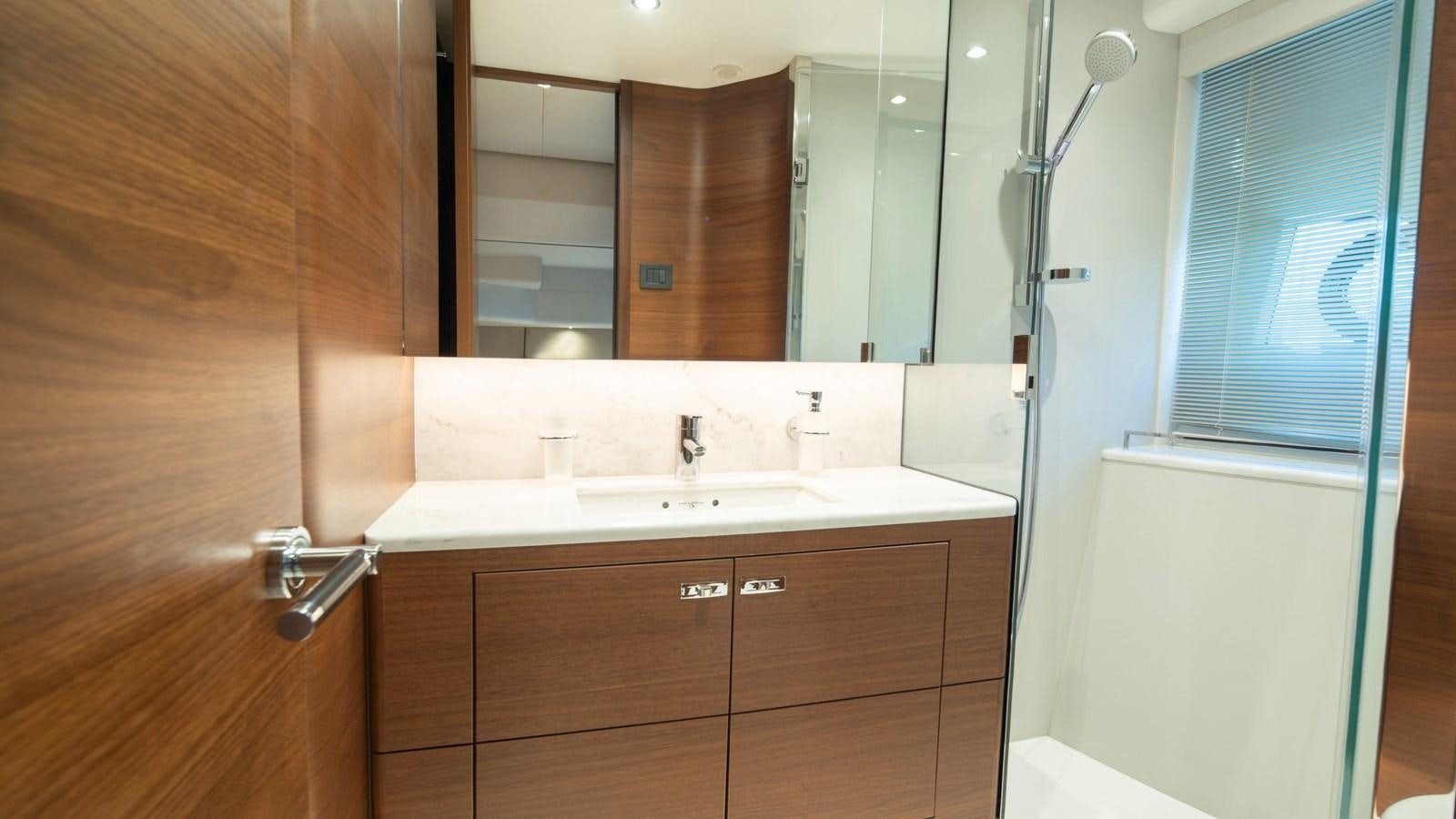 a bathroom with a mirror and a sink aboard SERENATA Yacht for Sale