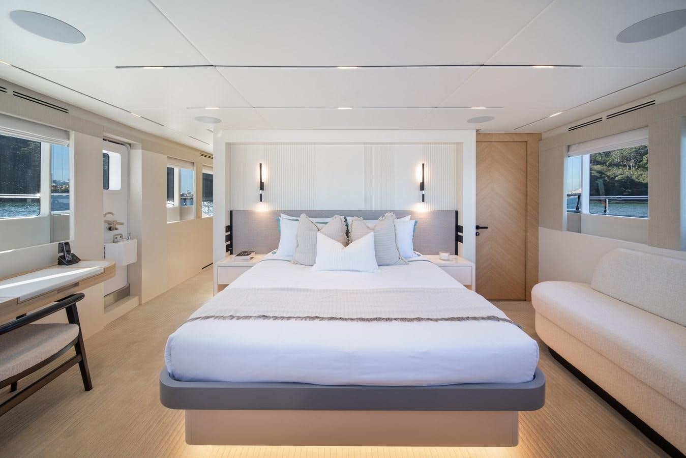 a large white bed in a room aboard BLUESTONE Yacht for Sale