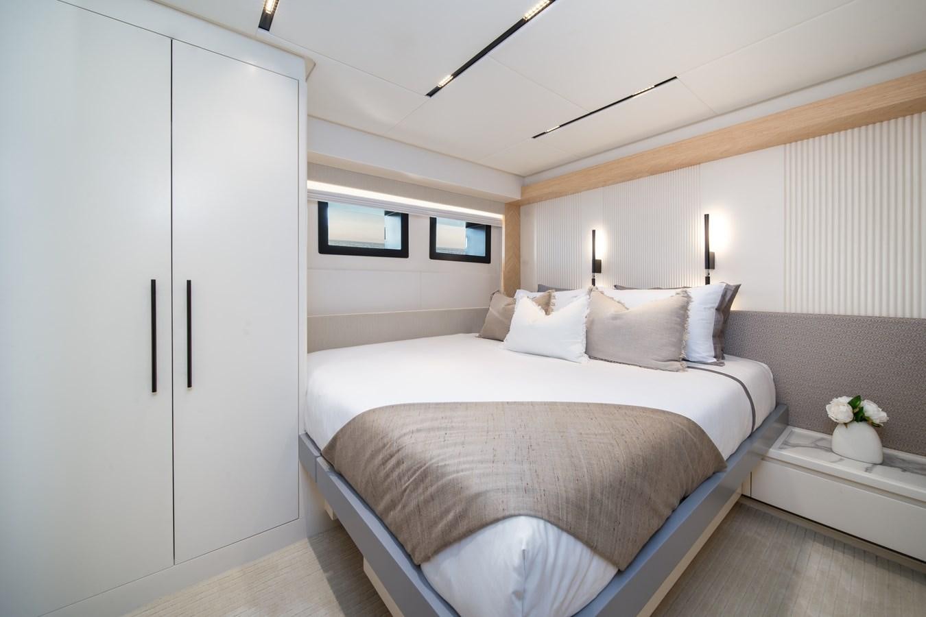 a bed with white sheets aboard BLUESTONE Yacht for Sale