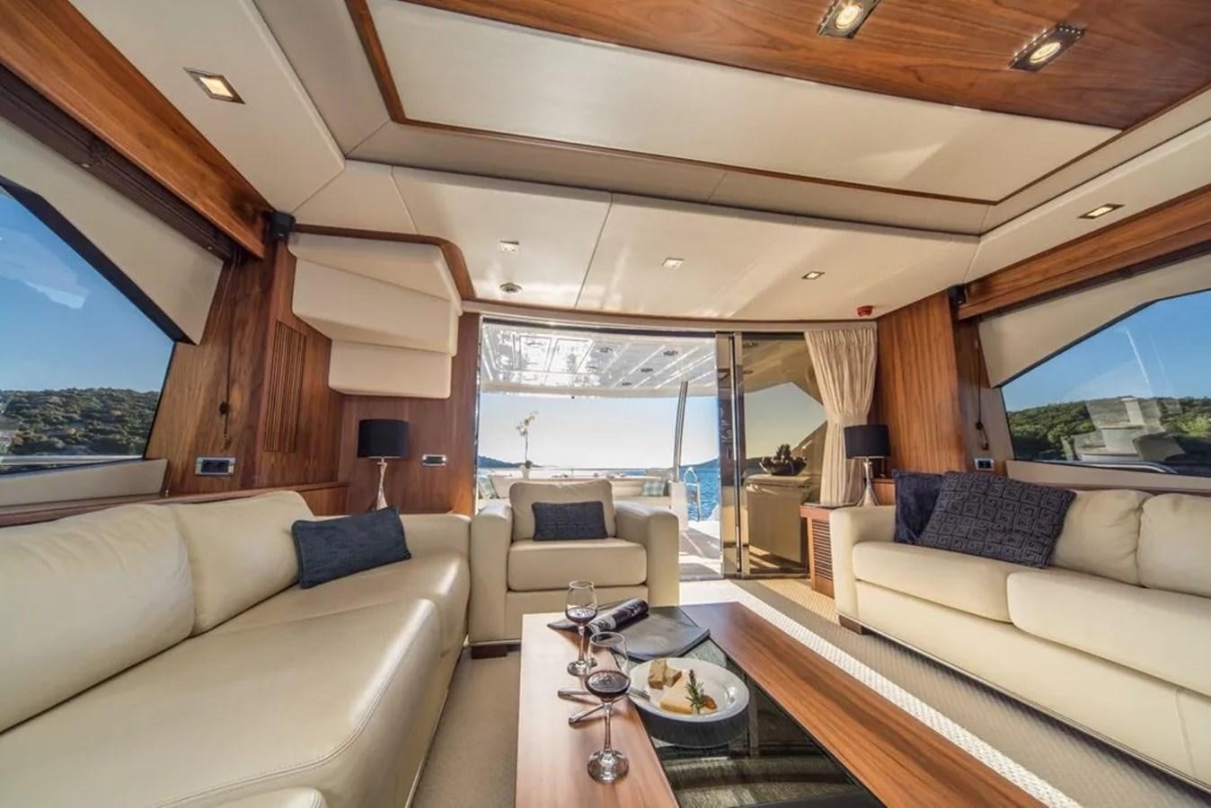 a living room with a large window aboard SUNSEEKER 84 Yacht for Sale