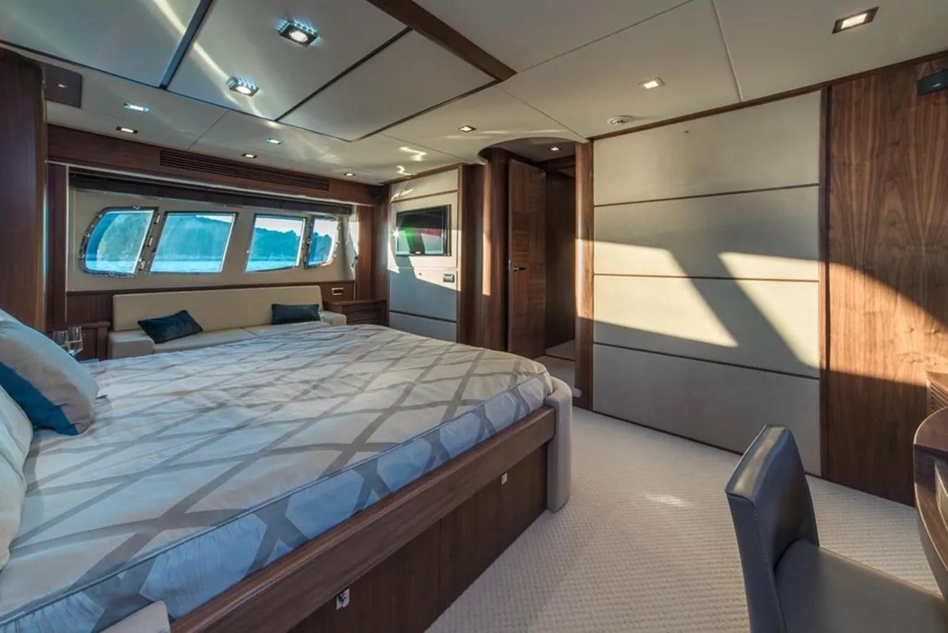a room with a bed and a window aboard SUNSEEKER 84 Yacht for Sale