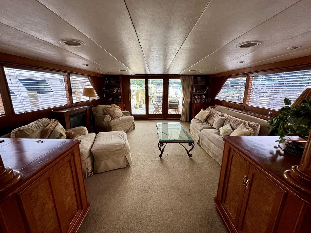 a living room with a couch and a table aboard BRAVEHEART Yacht for Sale