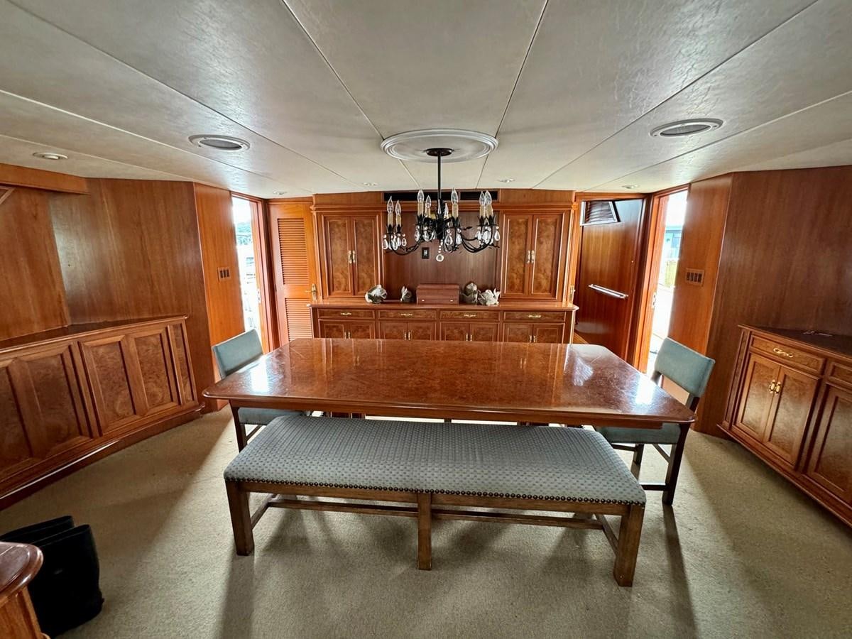 a large kitchen with a dining table aboard BRAVEHEART Yacht for Sale