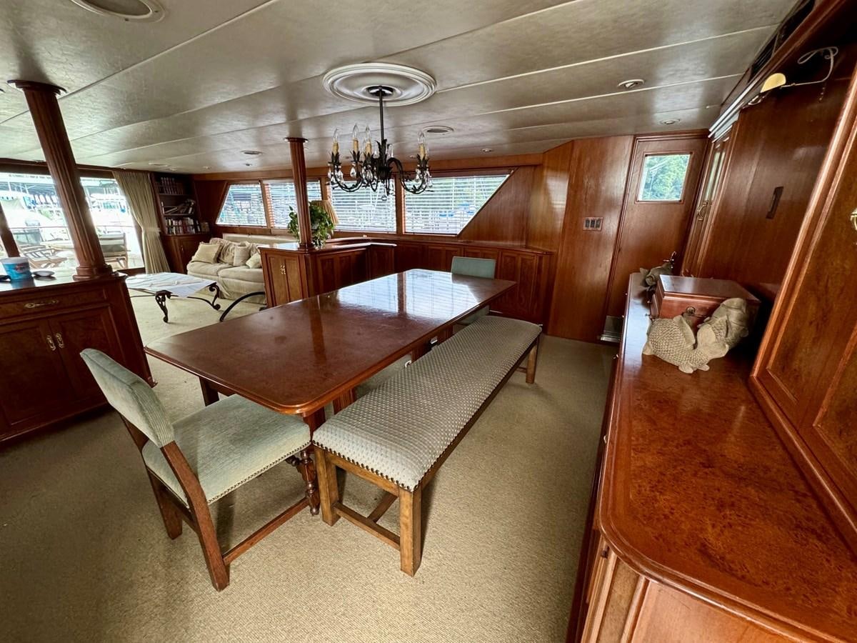 a room with a table and chairs aboard BRAVEHEART Yacht for Sale