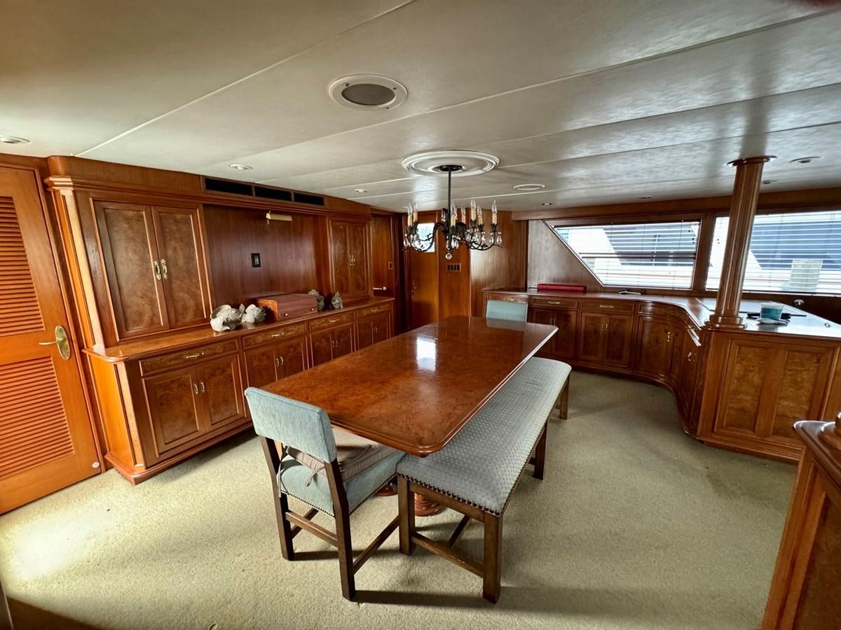 a room with a table and chairs aboard BRAVEHEART Yacht for Sale