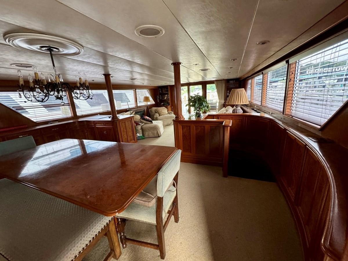 a room with a table and chairs aboard BRAVEHEART Yacht for Sale