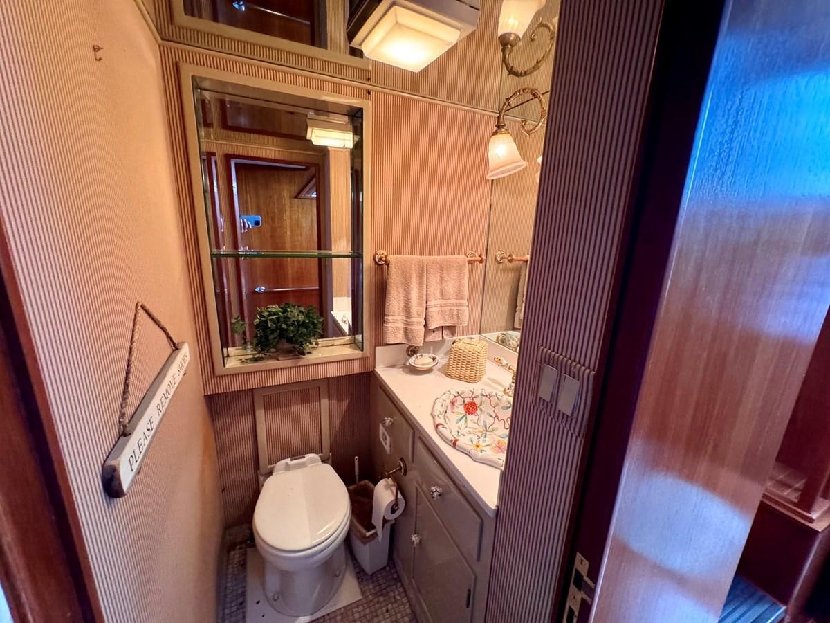 a bathroom with a toilet and a sink aboard BRAVEHEART Yacht for Sale
