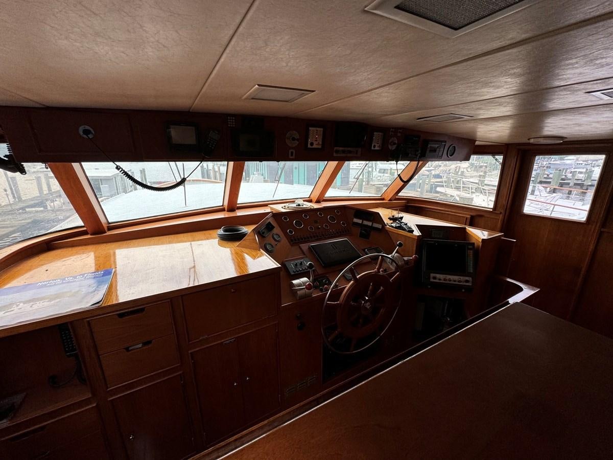 a large room with a table and a fan aboard BRAVEHEART Yacht for Sale