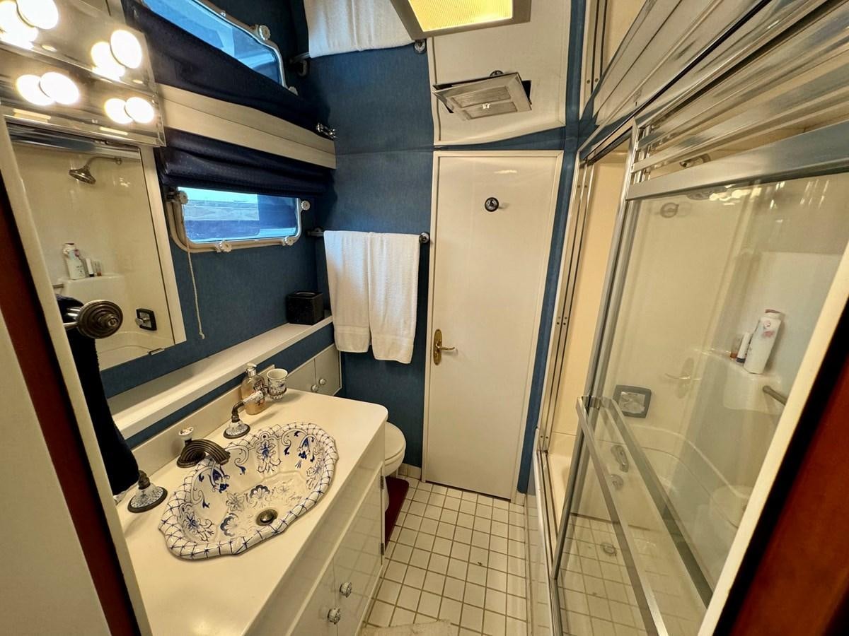 a bathroom with a tub sink and mirror aboard BRAVEHEART Yacht for Sale