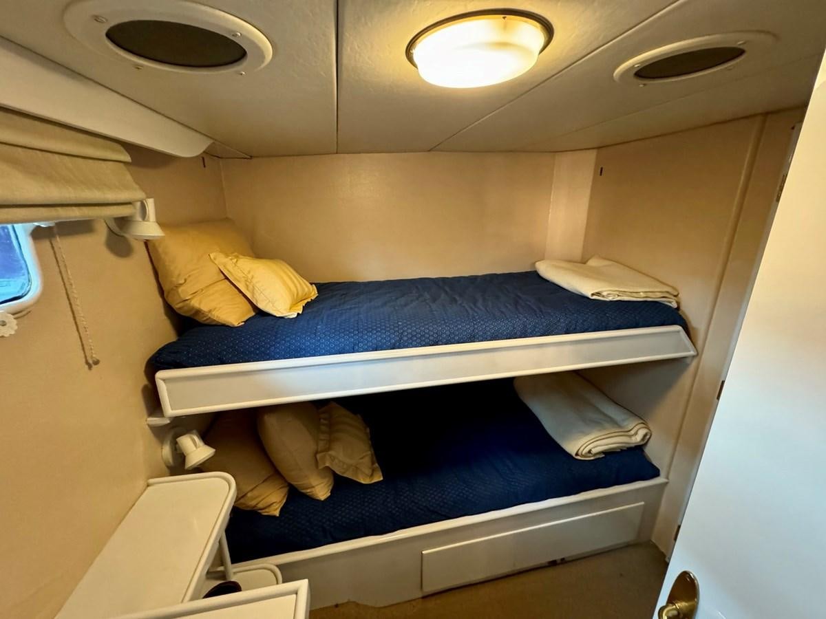 a small room with bunk beds aboard BRAVEHEART Yacht for Sale