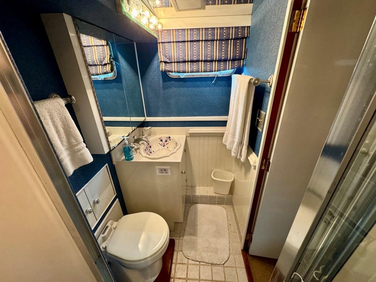 a bathroom with a toilet and a sink aboard BRAVEHEART Yacht for Sale