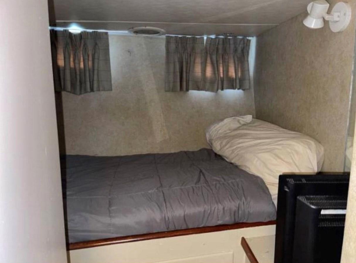 a bed in a room aboard BRAVEHEART Yacht for Sale