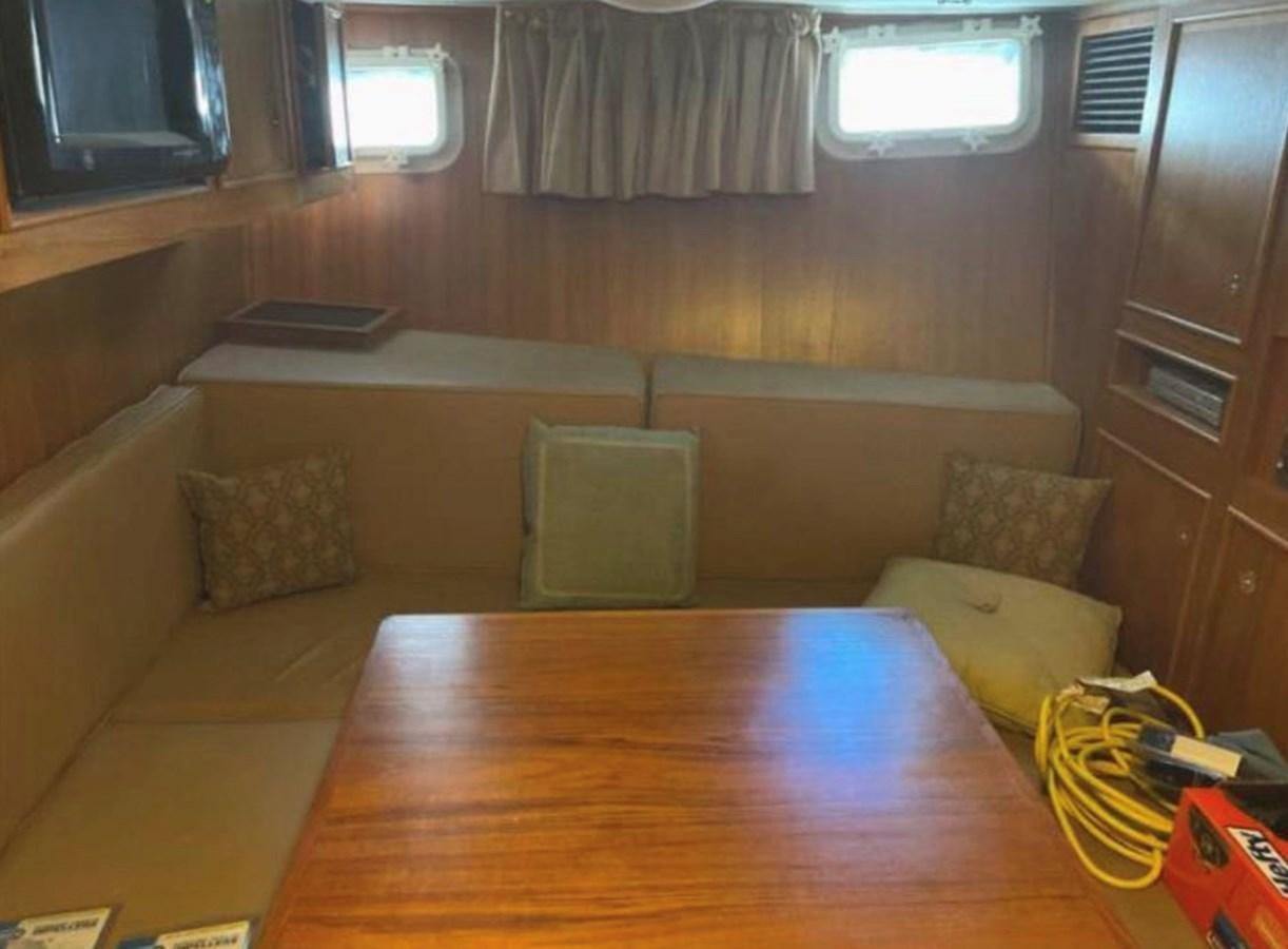 a room with a couch and a table aboard BRAVEHEART Yacht for Sale