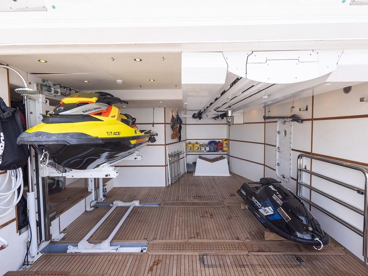 a room with a bed and a suitcase aboard ACE 2 Yacht for Sale