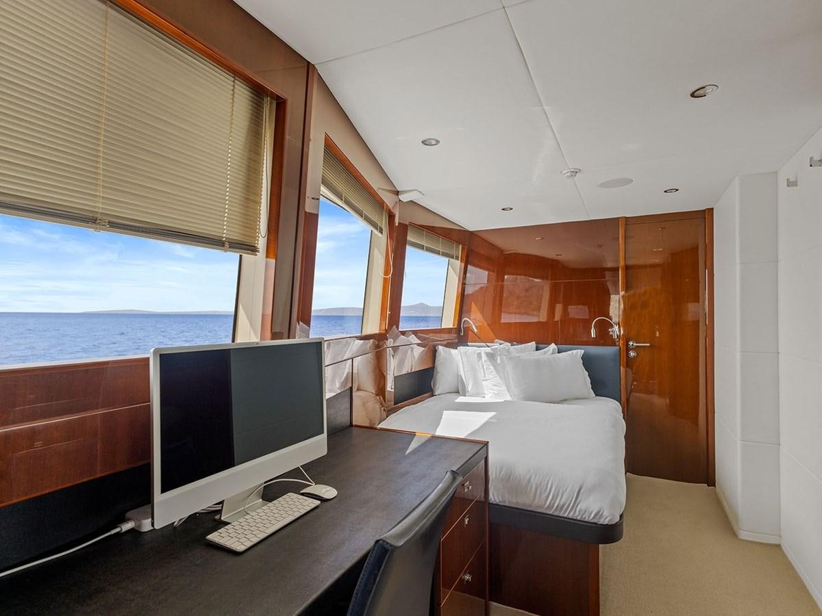 a bedroom with a bed and a desk aboard ACE 2 Yacht for Sale