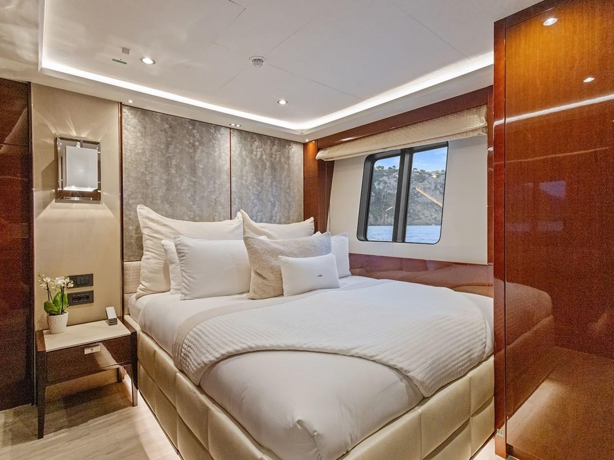 a bed with white sheets aboard ACE 2 Yacht for Sale