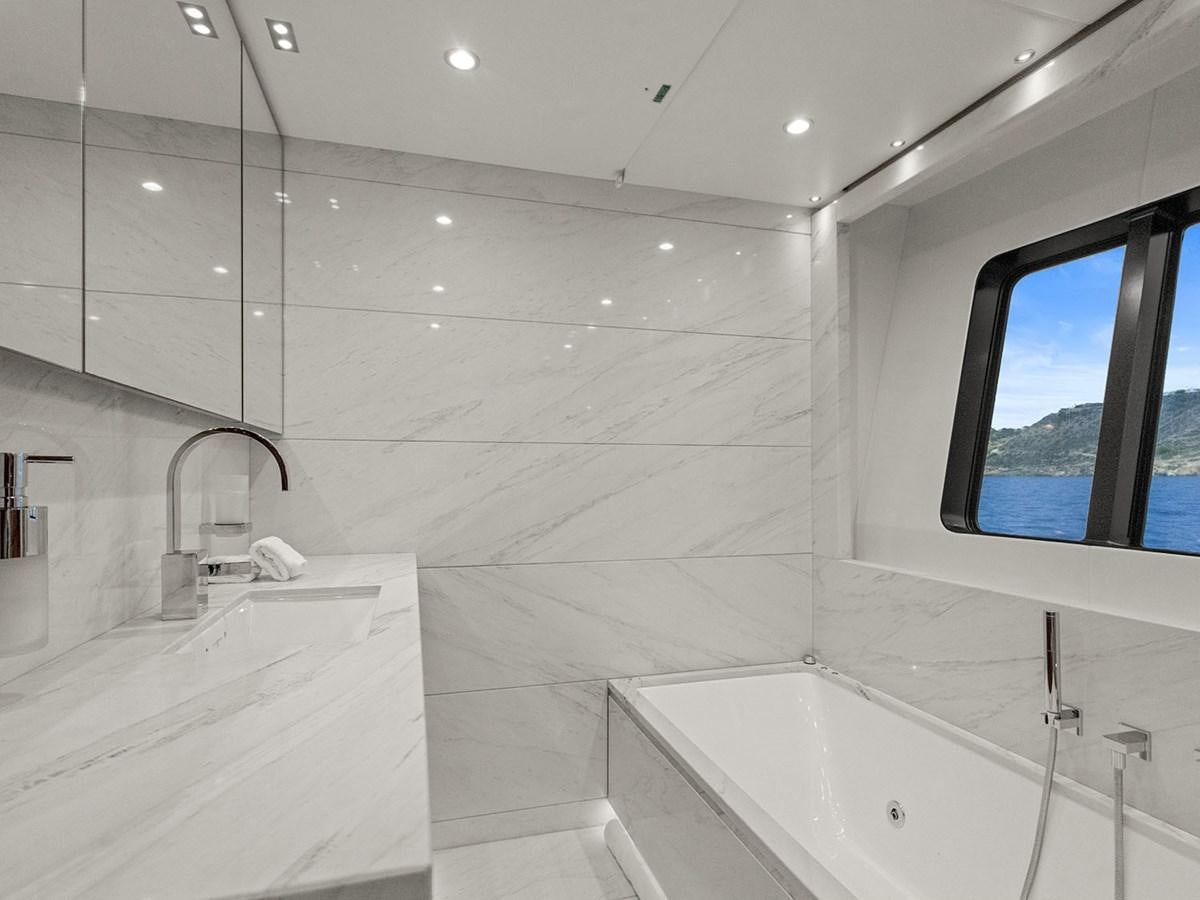a bathroom with a bathtub and a window aboard ACE 2 Yacht for Sale