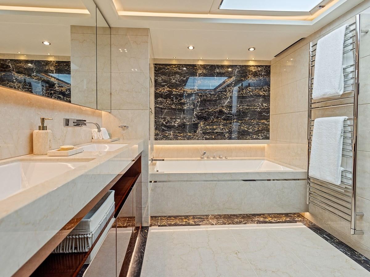 a bathroom with a tub sink and cabinets aboard ACE 2 Yacht for Sale