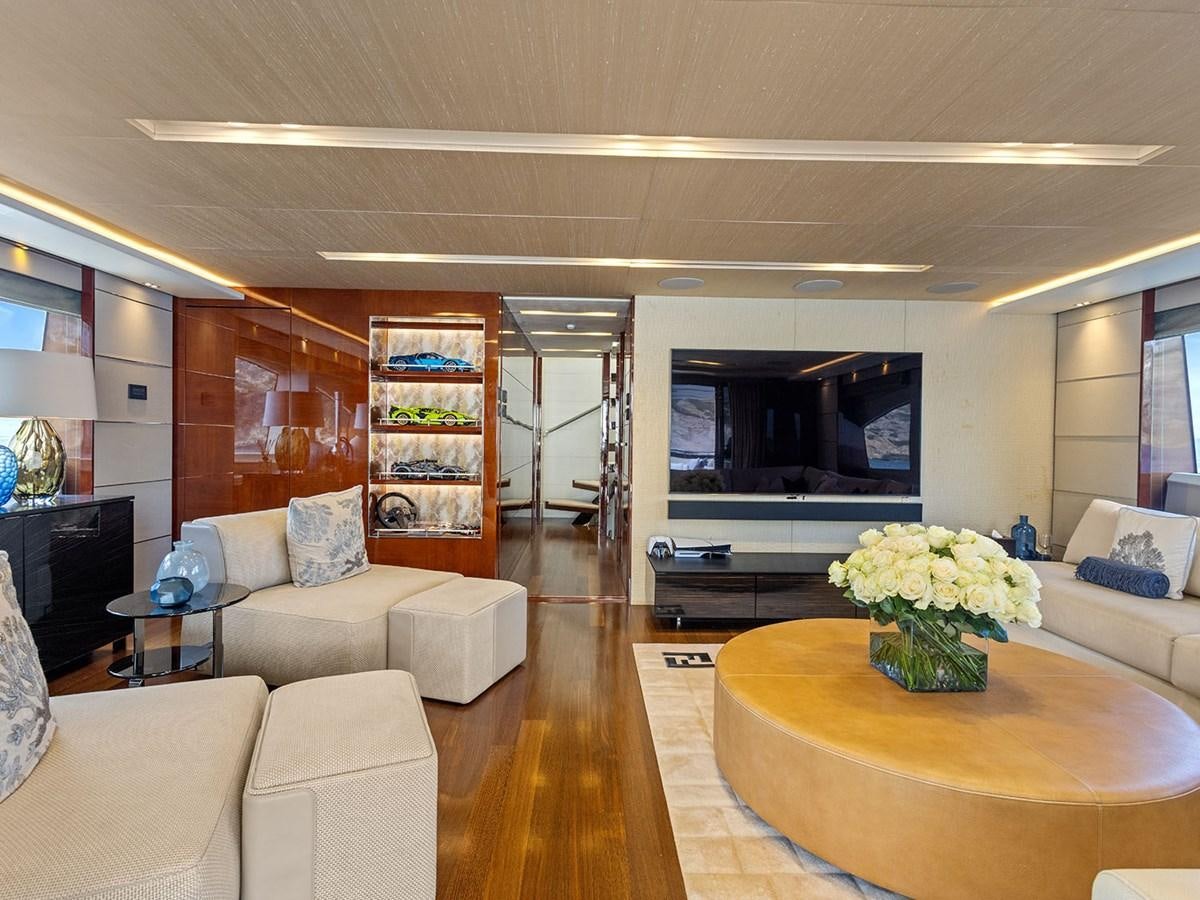 a living room with a large screen aboard ACE 2 Yacht for Sale