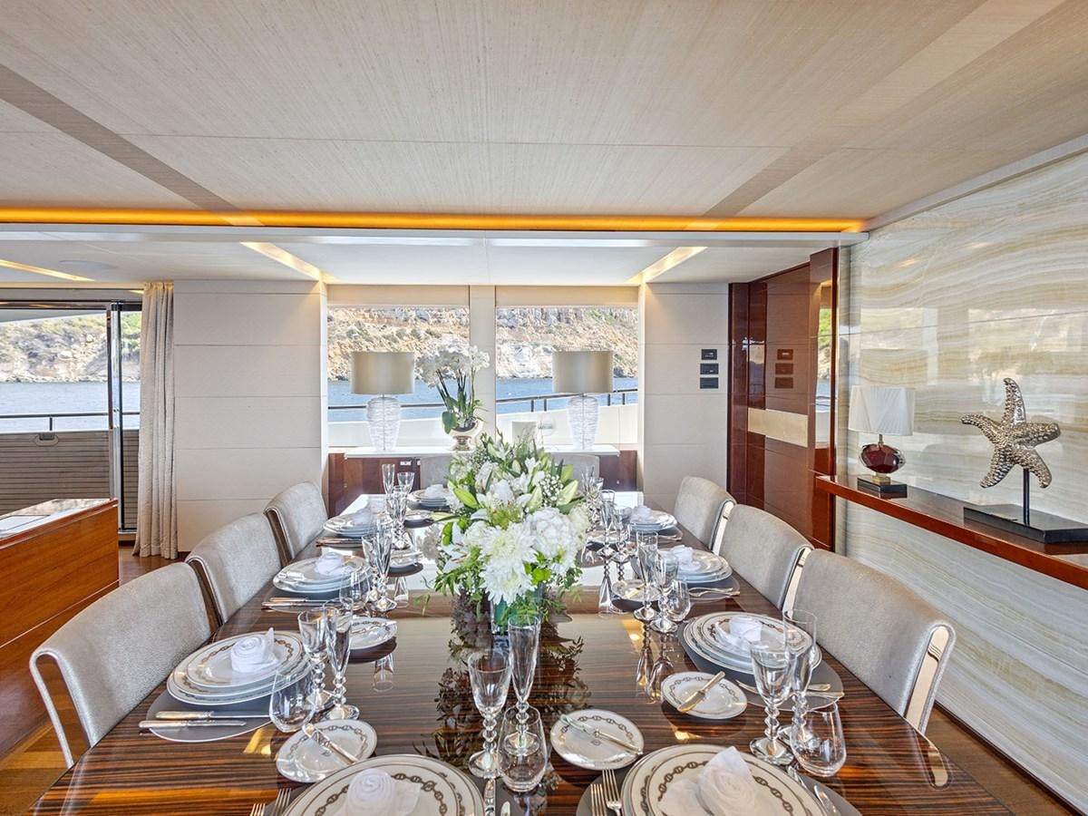 a dining room with a table set aboard ACE 2 Yacht for Sale
