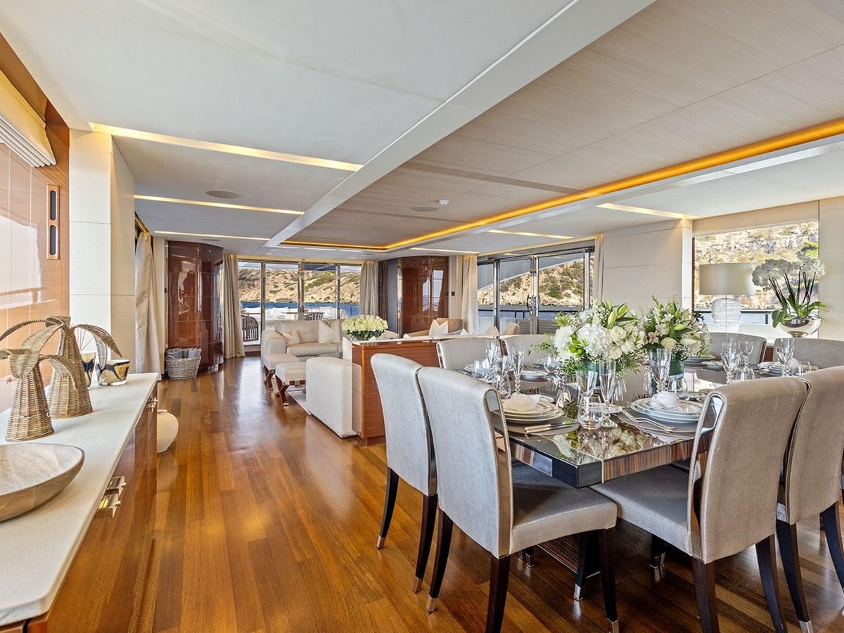 a large dining room with a kitchen and living room aboard ACE 2 Yacht for Sale