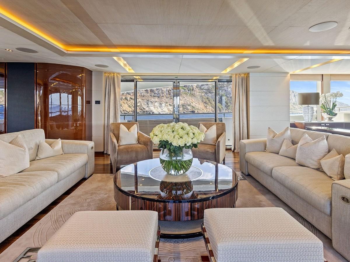 a living room with a table and chairs aboard ACE 2 Yacht for Sale