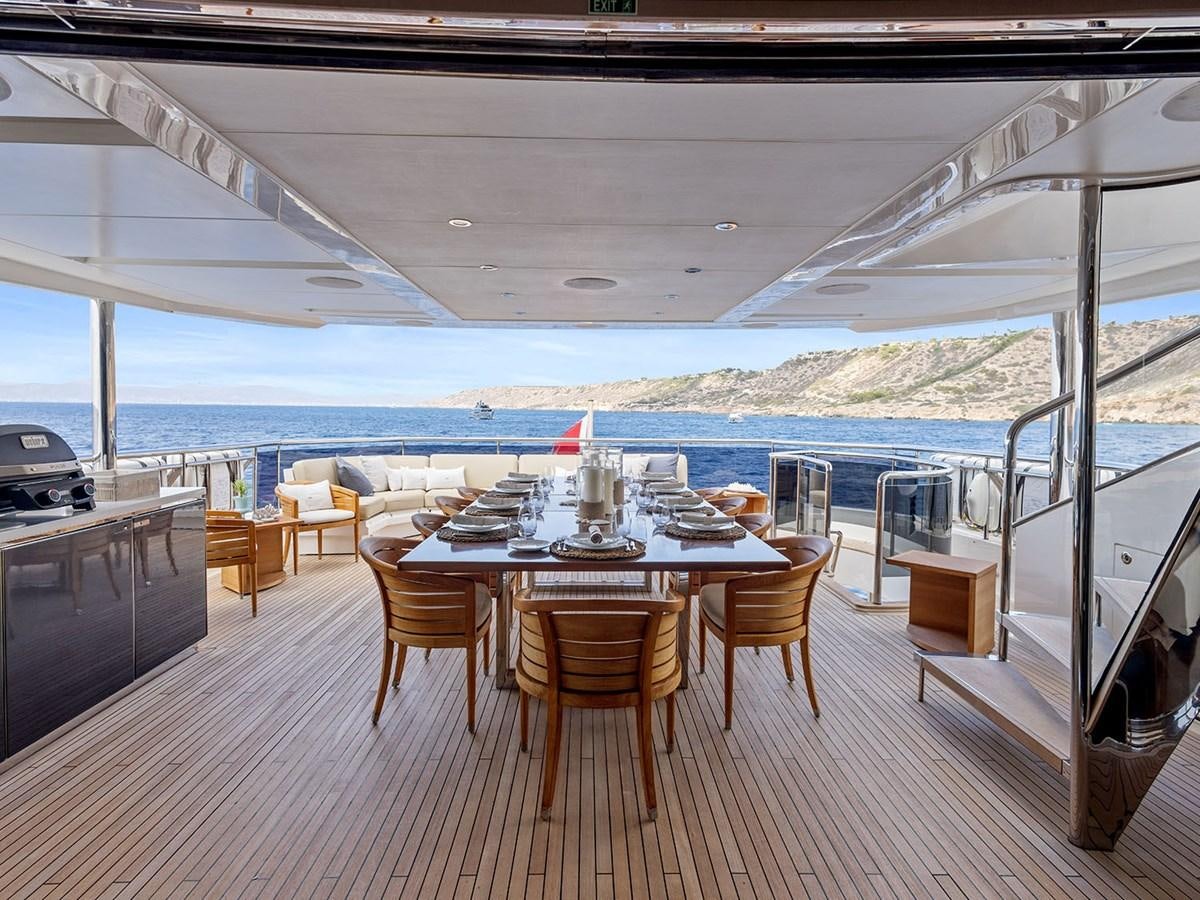 a table and chairs on a deck aboard ACE 2 Yacht for Sale