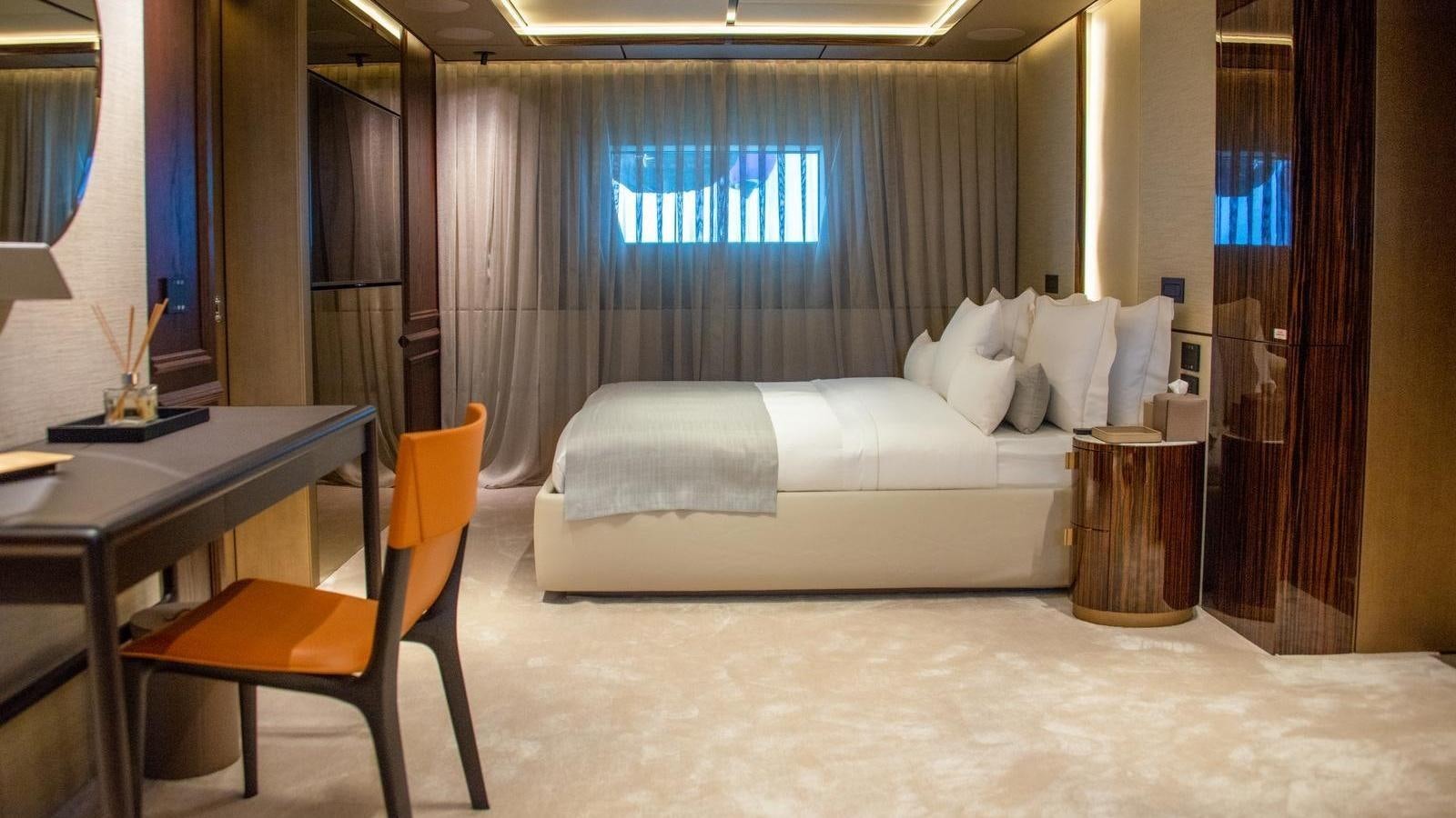 a room with a bed and a desk aboard GECO Yacht for Sale