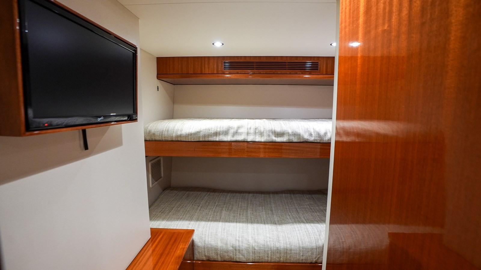 a room with a tv and a bed aboard GT 70 Yacht for Sale