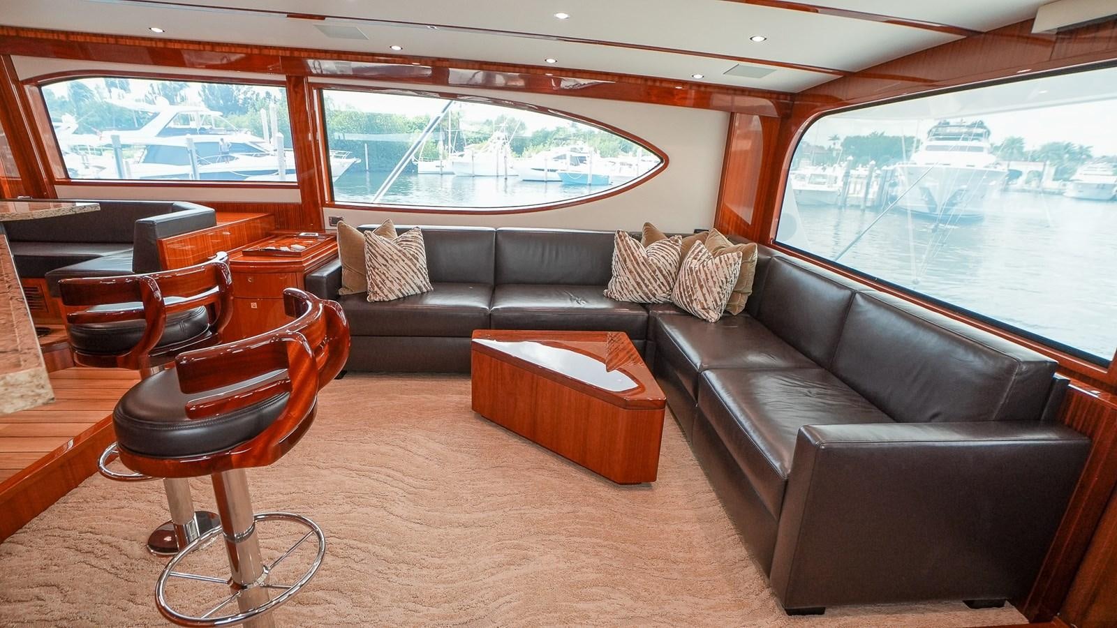a living room with leather couches aboard GT 70 Yacht for Sale