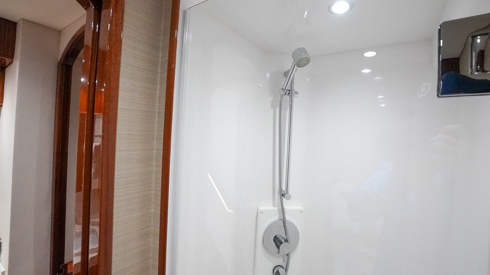a shower with a white wall aboard GT 70 Yacht for Sale