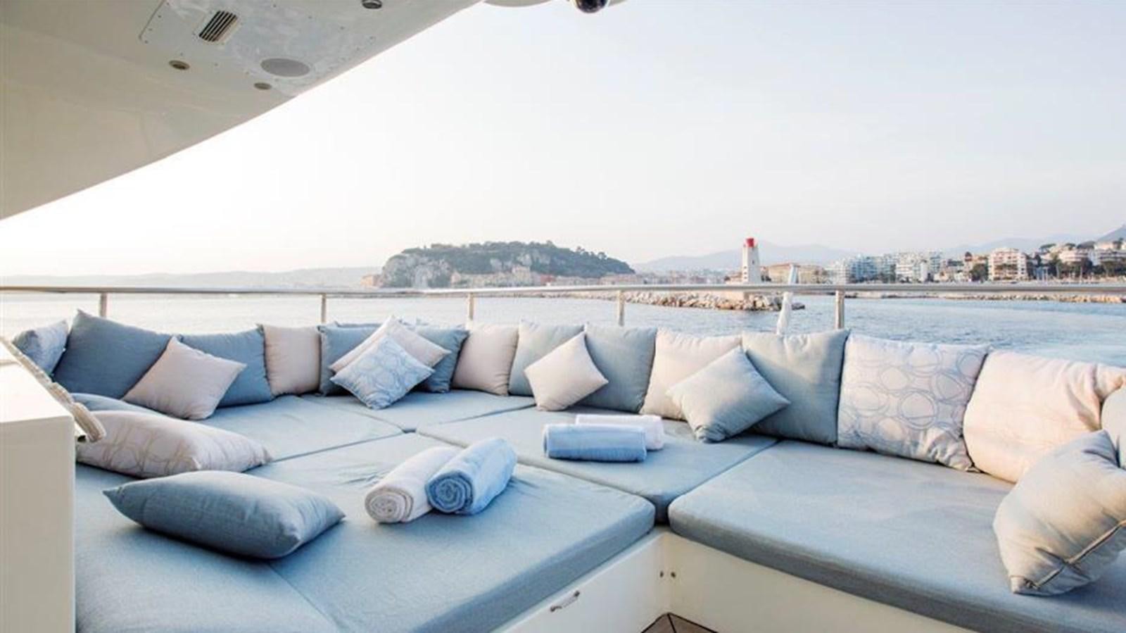 a couch with pillows on it aboard LIBERDADE Yacht for Sale