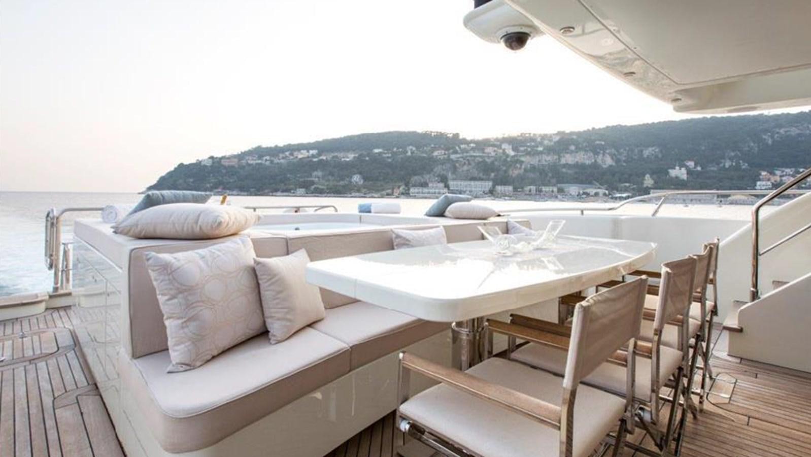 a deck with a couch and a table on it aboard LIBERDADE Yacht for Sale