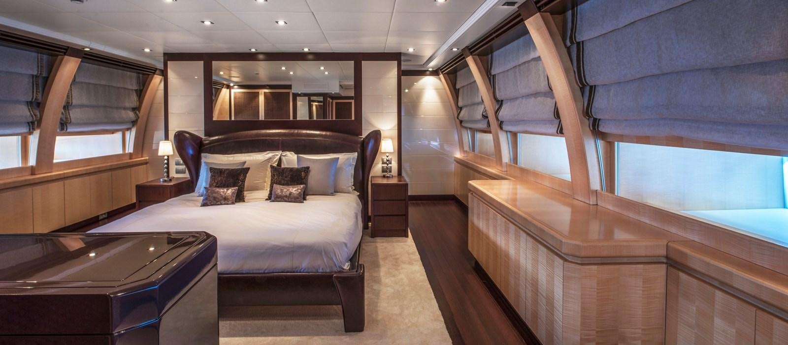 a room with a bed and a table aboard LIBERDADE Yacht for Sale