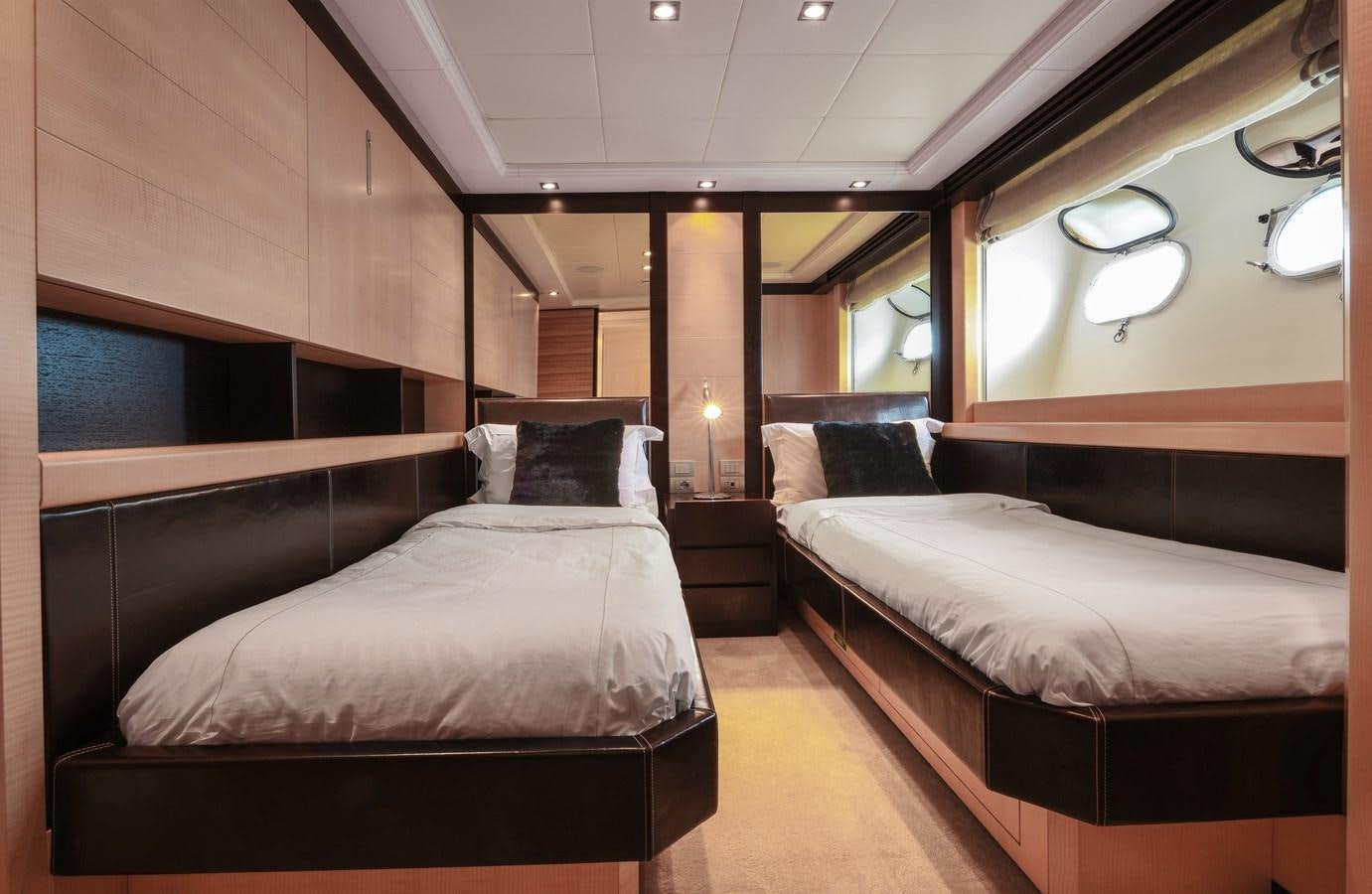 a room with a bed and a mirror aboard LIBERDADE Yacht for Sale