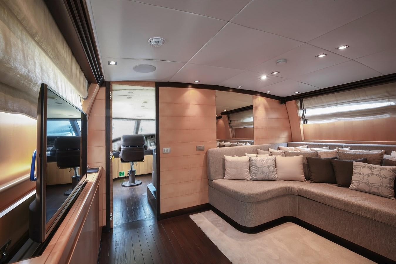 a living room with a couch and a tv aboard LIBERDADE Yacht for Sale