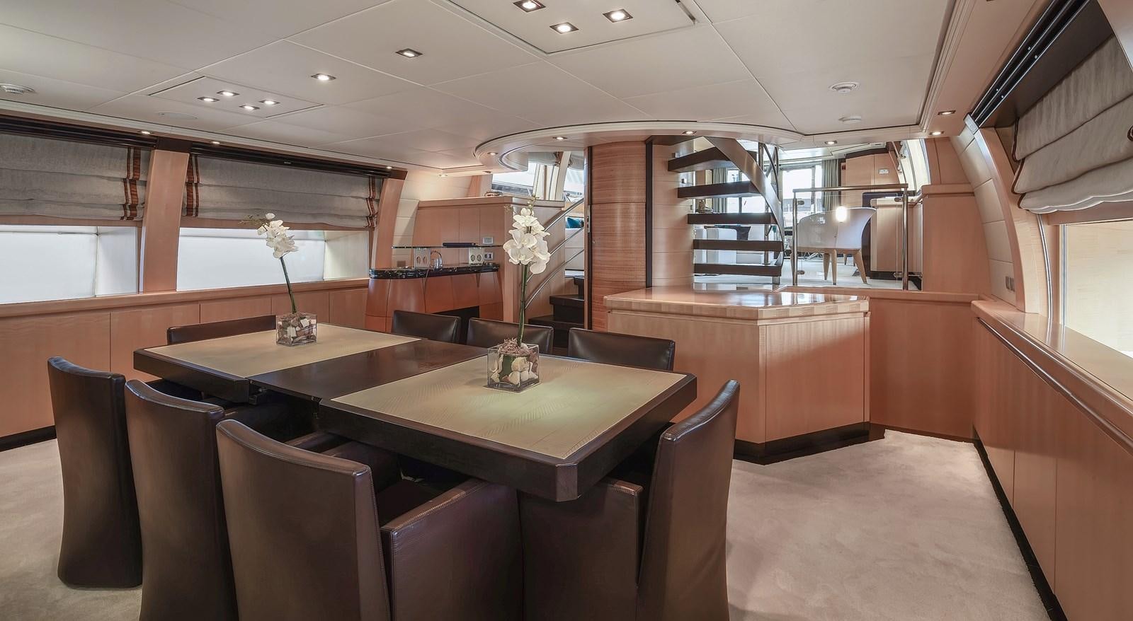 a room with a table and chairs aboard LIBERDADE Yacht for Sale