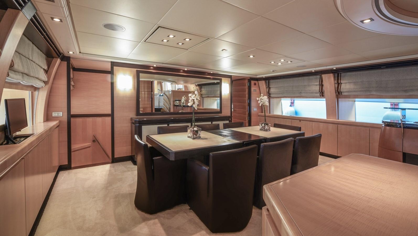 a room with tables and chairs aboard LIBERDADE Yacht for Sale