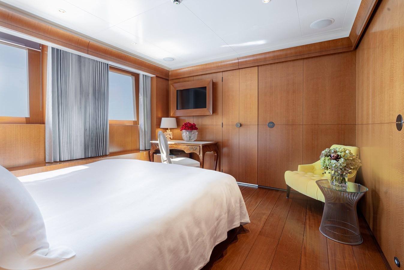 a room with a bed and a table aboard WEDGE TOO Yacht for Sale