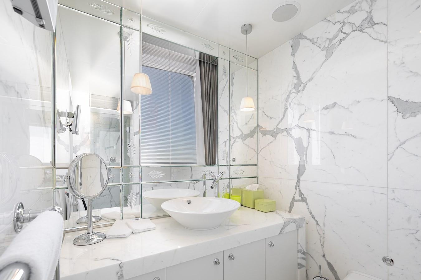 a bathroom with a sink and mirror aboard WEDGE TOO Yacht for Sale