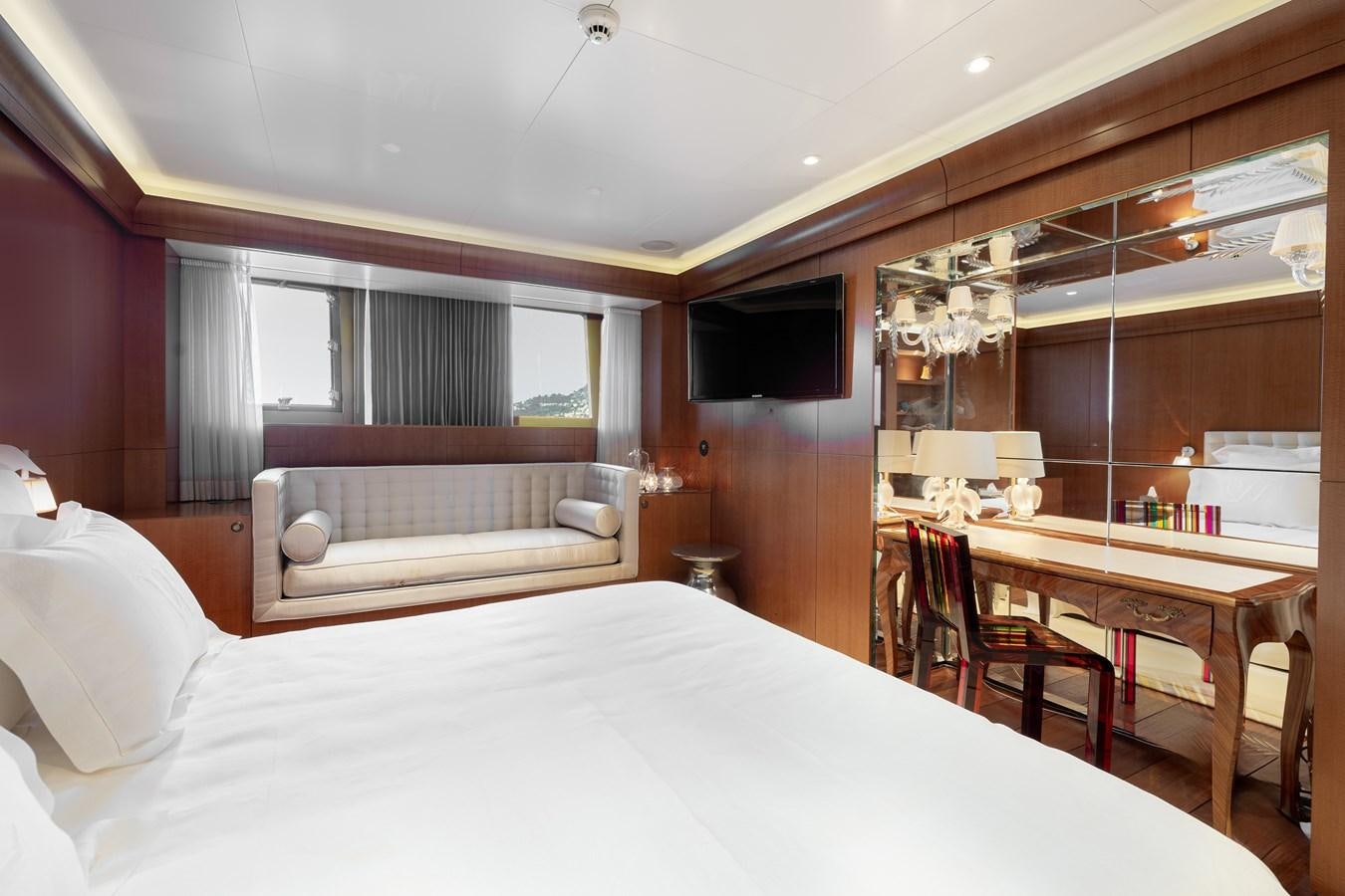 a bedroom with a bed and a desk aboard WEDGE TOO Yacht for Sale