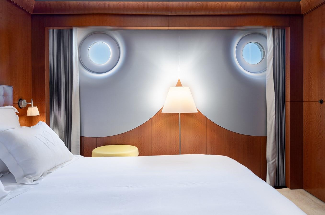 a bed with a lamp on it aboard WEDGE TOO Yacht for Sale