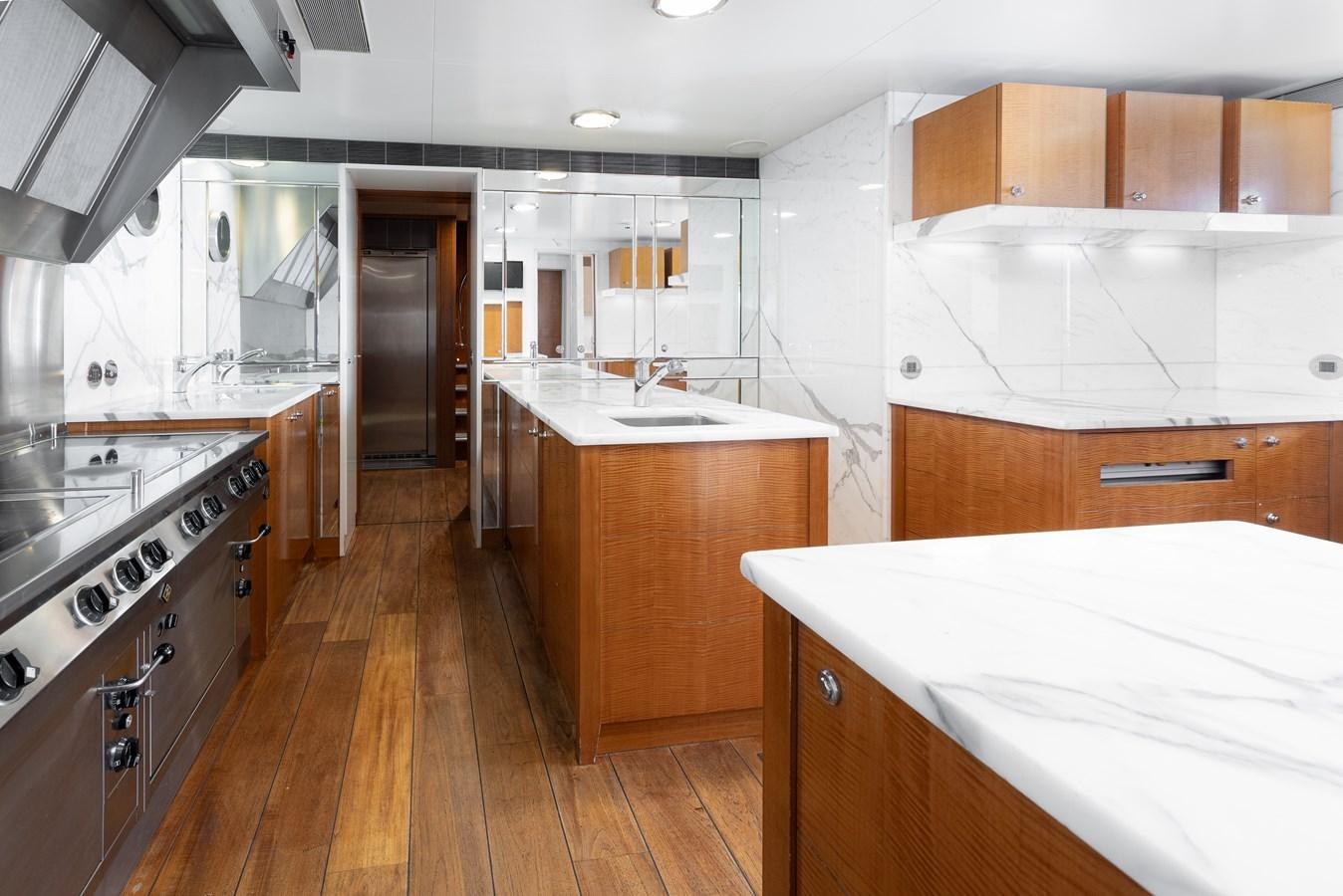 a kitchen with wooden cabinets aboard WEDGE TOO Yacht for Sale