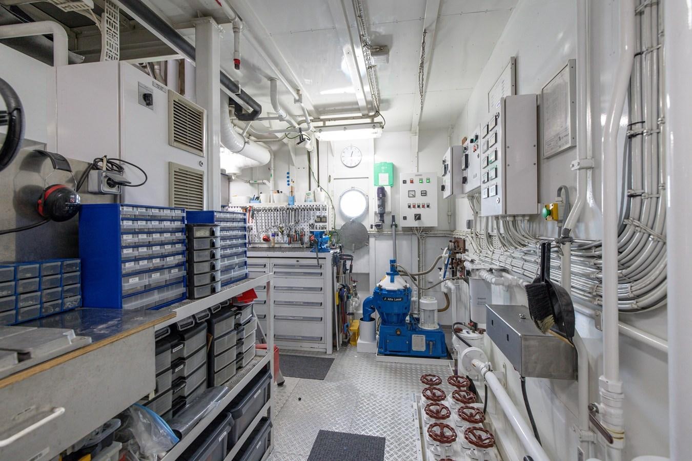 a room with white walls and blue machinery aboard WEDGE TOO Yacht for Sale