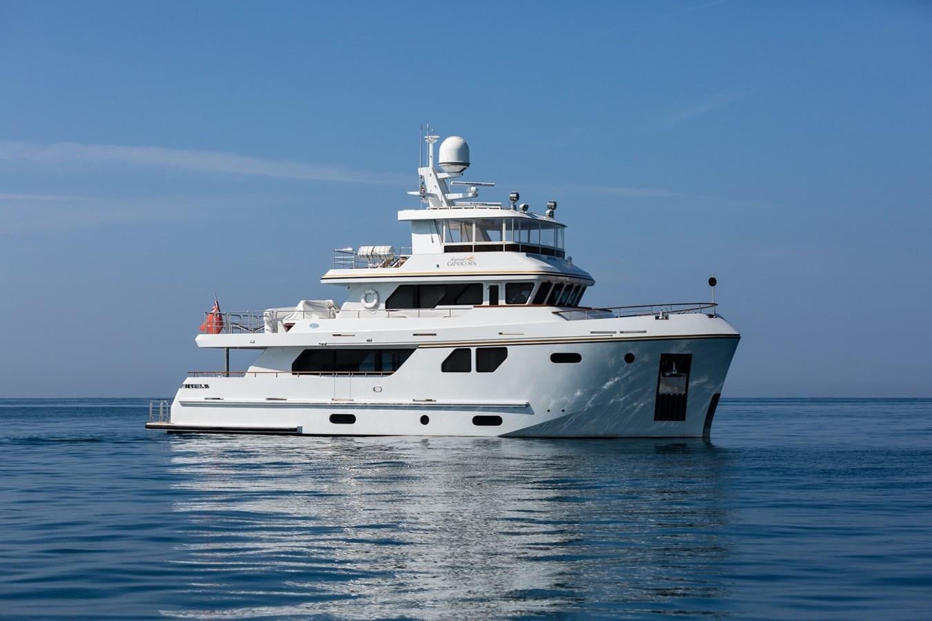 a white yacht in the water aboard BEYOND CAPRICORN Yacht for Sale