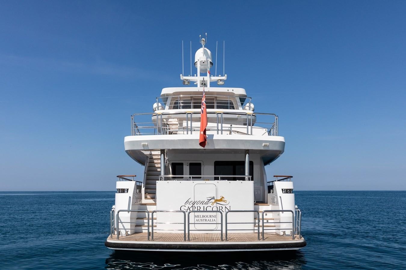 a large white boat in the water with Thomas Point Shoal Light in the background aboard BEYOND CAPRICORN Yacht for Sale