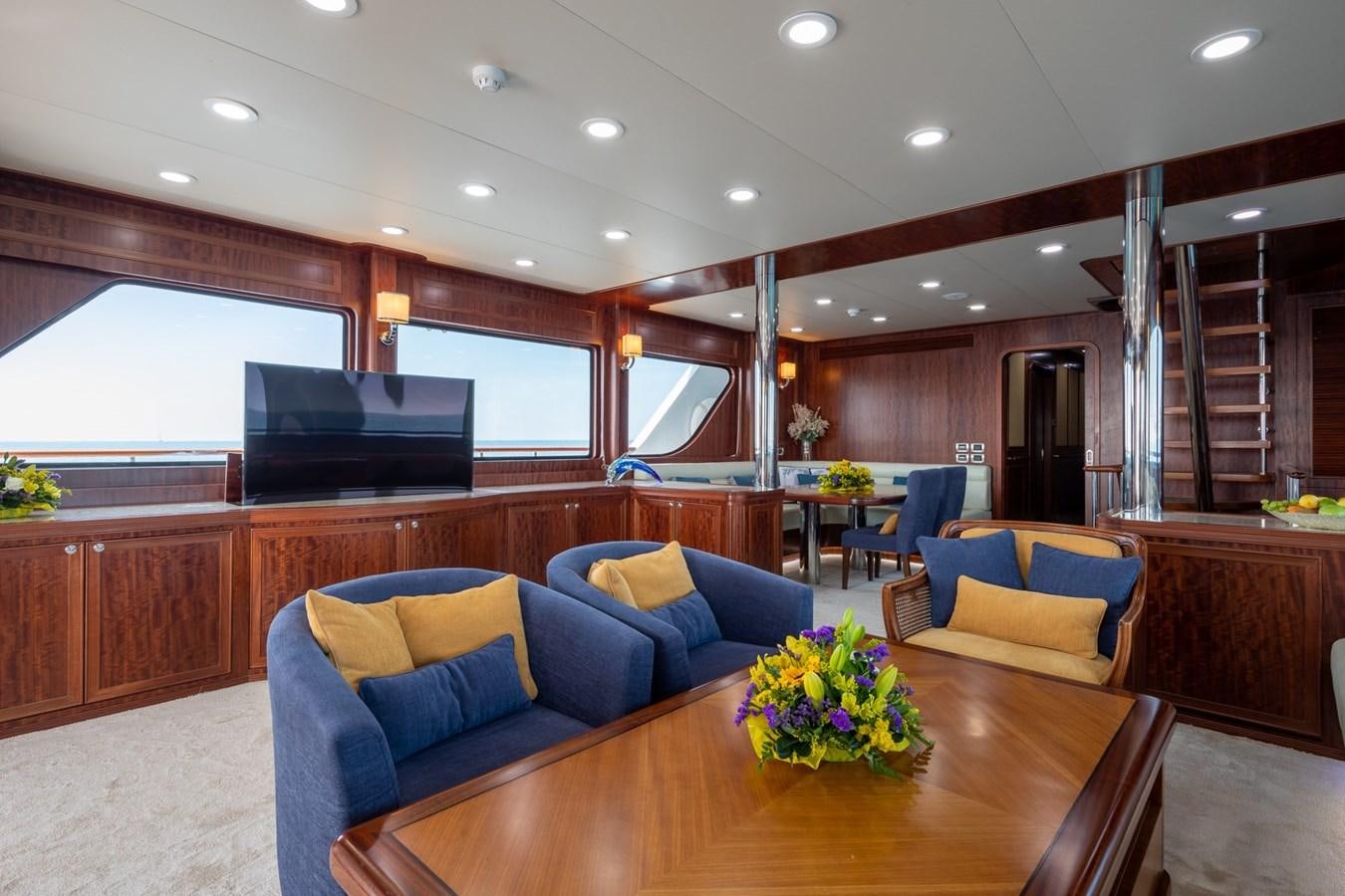 a living room with a blue couch aboard BEYOND CAPRICORN Yacht for Sale