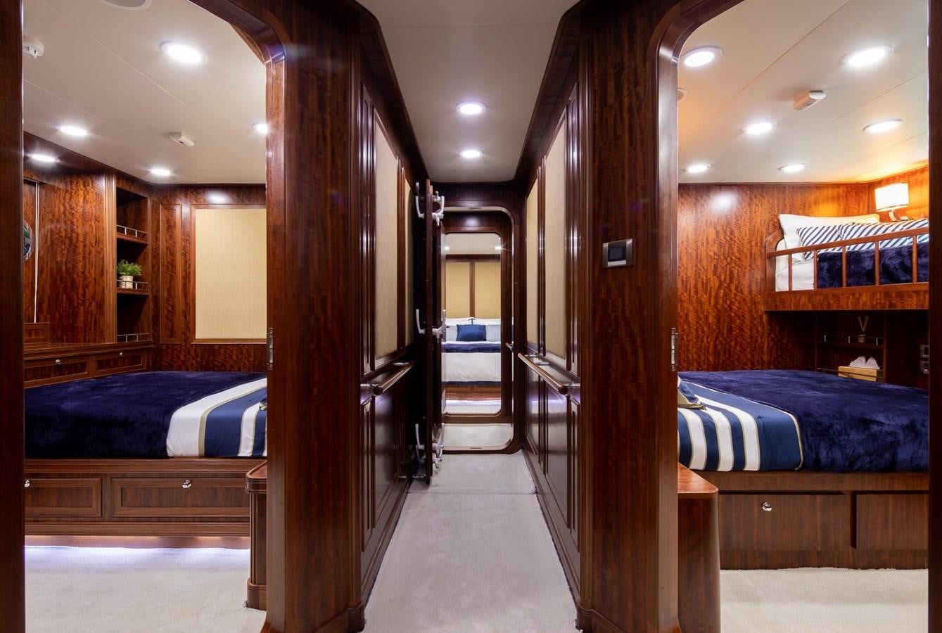 a room with wooden walls and a bed aboard BEYOND CAPRICORN Yacht for Sale